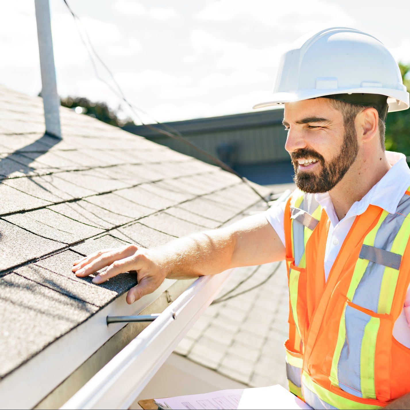 A man inspecting a roof for solar panel installation