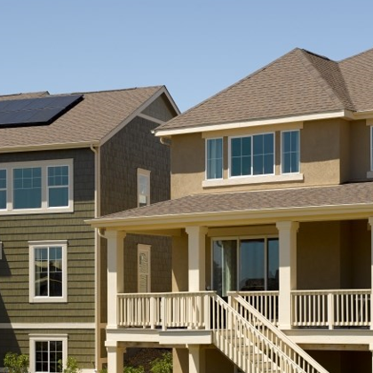 Two homes side by side with solar panels on the roof