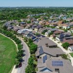 A large neighborhood with solar panels on every roof